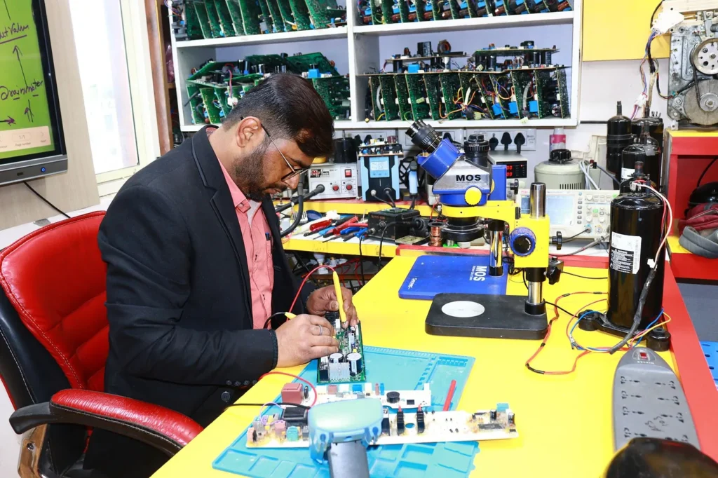 Appliance control board being repaired at an electronics workbench
