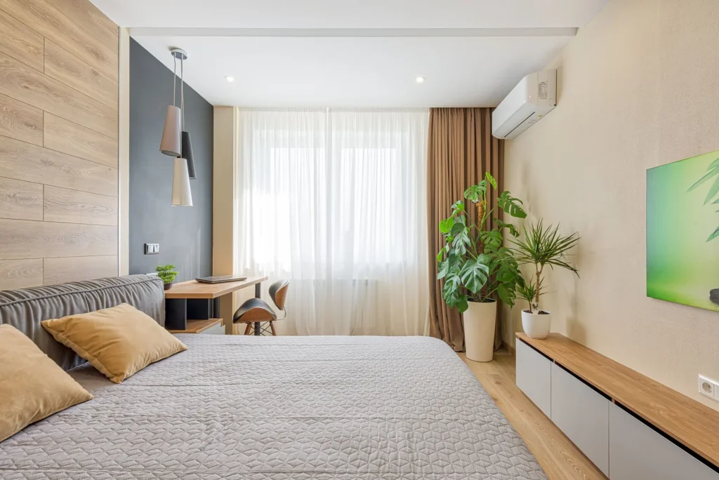 Wall-mounted split air conditioner cooling a bedroom